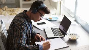 Guy with headphones in front of laptop
